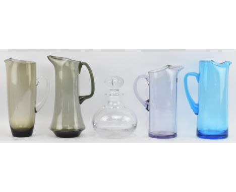 Whitefriars, Holmegaard &amp; similar - a collection of four vintage mid century glass ewer jugs. Comprising a ewer in blue, 