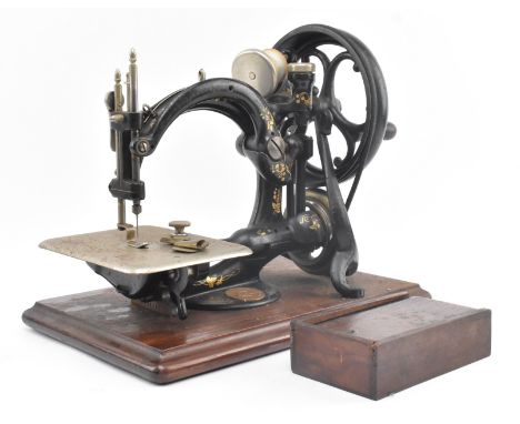 



Willcox &amp; Gibbs - An early 20th century Willcox &amp; Gibbs hand crank sewing machine in original mahogany case. The 