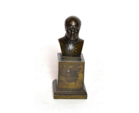 A small bronze bust of a gentleman on a square plinth base