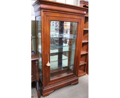 A 20th century cherry wood display cabinet, fitted single bevel plate door revealing mirrored interior with glass shelves, 94