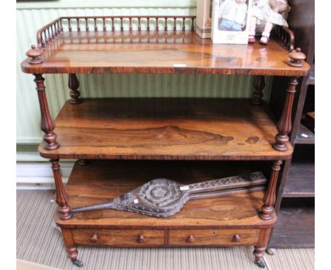 A 19th century Rosewood three tiered buffet, the top having galleried back &amp; half sides, supported by baluster columns, t