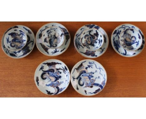 A collection of Chinese Qianlong porcelain tea bowls and saucers, hand painted cobalt and pink dragon decoration, comprising 