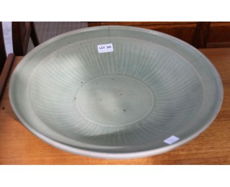 A large Chinese Celadon glazed charger, in the manner of Longquan, 43cm diameter (AF) Cracked, three cracks coming from rim 