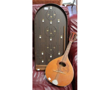 A stringed instrument and a "Corinthian Master" game bagatelle game