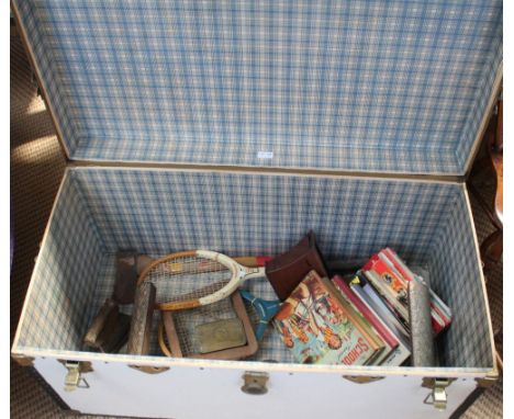 A white trunk containing annuals, tennis racquets, etc
