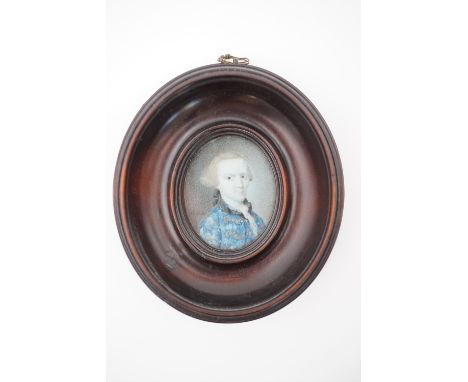 A George III portrait miniature on ivory, depicting a gentleman in wig and gilt-braided blue frock coat,  signed "Tisch***", 