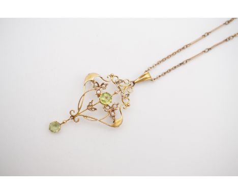 A Belle Epoque Art Nouveau peridot and pearl pendant brooch, in an openwork arrangement incorporating whiplash pearl set fron