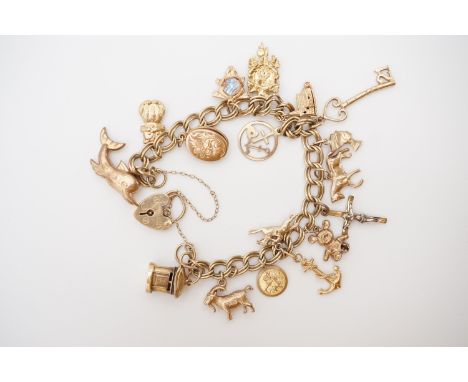 A 9ct gold charm bracelet and charms, including post box, chapel, racehorse, cuckoo clock and cat etc, 31.2g