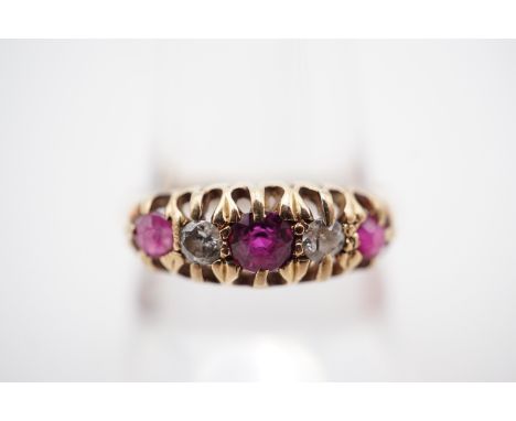 An antique 18ct gold, ruby and diamond dress ring, having a central round-cut ruby of approximately .24ct, flanked by brillia