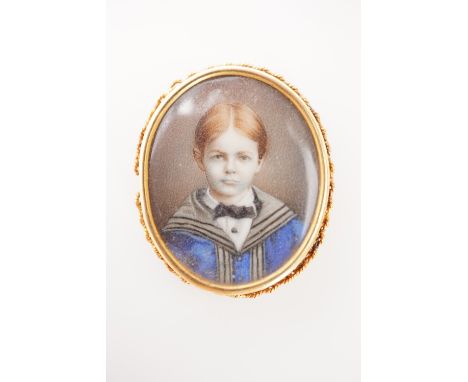 A late 19th Century hand-painted portrait miniature of a young boy in academic robes, in yellow-metal frame, under glass, 3 c