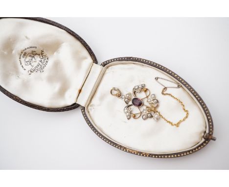 A Belle Epoque Art Nouveau gilt white metal, amethyst and pearl pendant, in an openwork arrangement, having a central oval-cu
