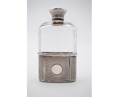 A Victorian silver mounted cut-glass hip flask, with screw cap, having guilloche engraved decoration surrounding a vacant car