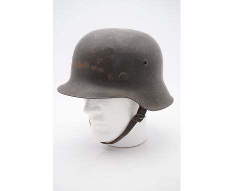 A German Model 1942 helmet retaining its original factory-applied finish, the shell faintly stamped ET or EF6*