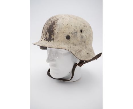 A German Model 1942 helmet in Luftwaffe blue with white over-paint, the shell stamped NS64 and the dome stamp apparent