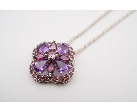 A contemporary 9ct white gold, amethyst and pink tourmaline pendant, in a quatrefoil flower head arrangement, with pelleted r