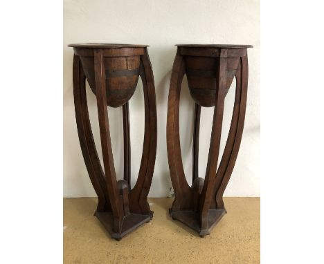 A pair of Art Deco influenced floor standing jardinieres, each having brass-banded turned oviform flower holders supported on