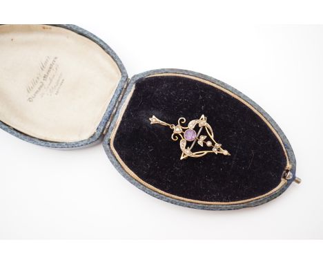 A Belle Epoque Art Nouveau amethyst and pearl openwork pendant brooch, having a central round-cut amethyst of approximately .