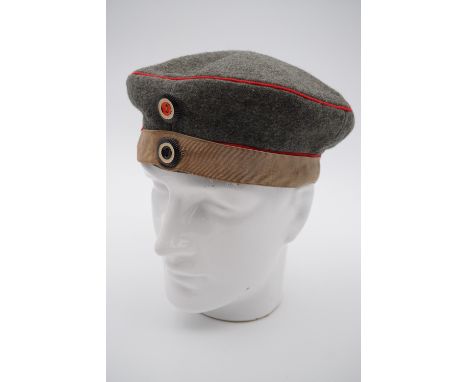 An Imperial German Model 1910 Prussian infantry Issue field cap / krätzchen with regulation camouflage band