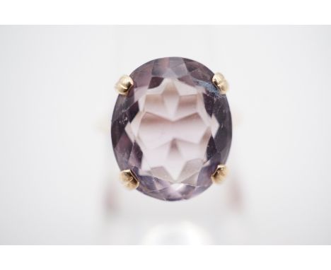 A pale amethyst cocktail ring, claw set above a geometric gallery, on a reverse tapering shank, K, 3.8g