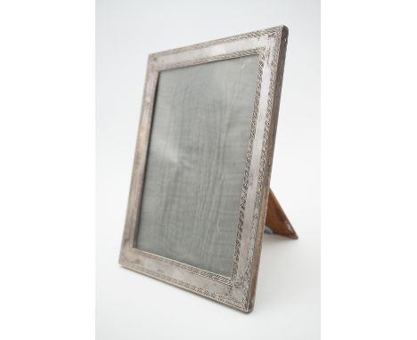 A 1920s silver photograph frame, with reed-and-ribbon pattern borders, and an oak easel back, Henry Matthews, Birmingham, 192