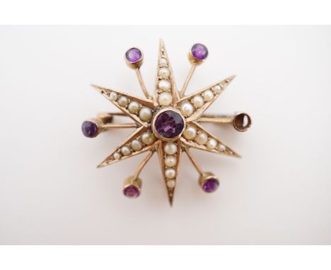 A Belle Epoque yellow metal, amethyst and pearl brooch in the form of a starburst, stamped '9ct', 2.7g (a/f)