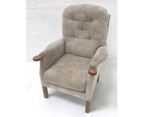 UPHOLSTRED ARMCHAIRwith a button back above shaped arms and a stuffover seat, standing on plain supports 