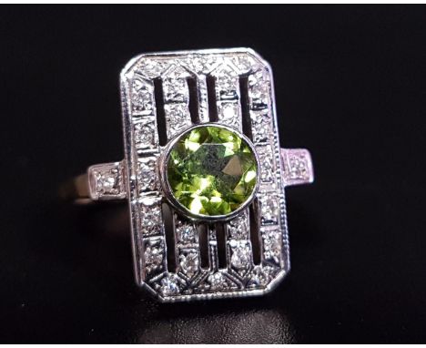 ART DECO STYLE PERIDOT AND DIAMOND PLAQUE RINGthe central round cut peridot approximately 1ct in pierced multi diamond surrou