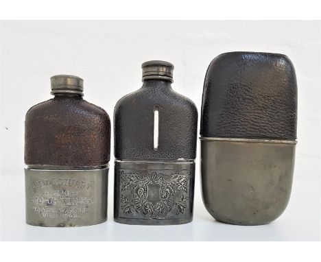 THREE VINTAGE LEATHER AND GLASS HIP FLASKSwith removable silver plated/pewter cups, one cup section engraved '"Jamie Stewart"