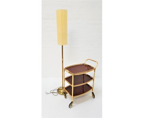 GILT METAL HOSTESS TROLLEYthe three tier trolley with removable tray top; together with a brass standard lamp with column sha