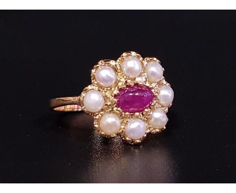 RUBY AND PEARL CLUSTER RINGthe central oval cabochon ruby in eight pearl surround, on nine carat gold shank, ring size L 