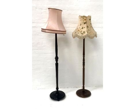 STAINED MAHOGANY STANDARD LAMPraised on circular base with tapering column and shade, 154cm high excluding shade; together wi