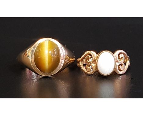 TWO GEM SET NINE CARAT GOLD RINGScomprising an oval cabochon opal ring with decorative pierced shoulders, ring size J; and a 