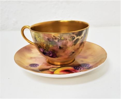 ROYAL WORCESTER CUP AND SAUCERthe cup hand painted by William Bagnall depicting cherries and peaches, with gilt interior, the
