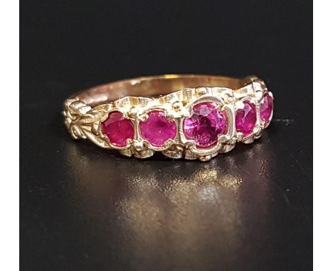 GRADUATED RUBY FIVE STONE RINGthe central ruby approximately 0.3cts, in scroll decorated setting and with decorative shoulder