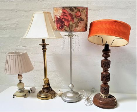 SELECTION OF FOUR ASSORTED TABLE LAMPSall with shades, one carved teak, 64cm high, brass lamp, 75cm high, alabaster lamp, 40.