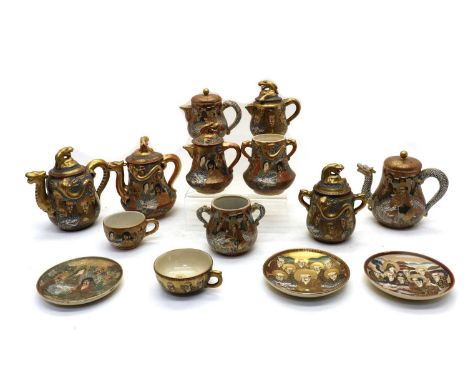 A collection of Japanese Satsuma ware,early 20th century, comprising: three teapots, three milk jugs, three sugar bowls, four