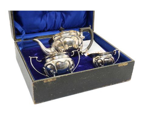 A cased three piece Edwardian silver tea service, by Joseph Rogers &amp; Sons, Sheffield 1908, comprising a teapot, 28cm wide