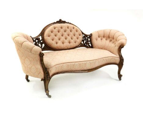 A mid-Victorian walnut framed chair end sofa,button upholstered back to a serpentine seat, with carved show-wood, on swept le