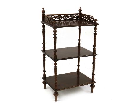 A late Victorian mahogany whatnot,of three open tiers, with finials, a fret carved three quarter gallery, twist carved column