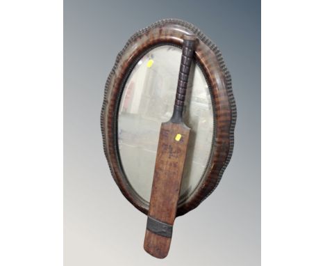 A 19th century mahogany oval scalloped edged mirror together with a vintage Herbert Sutcliffe autograph cricket bat 