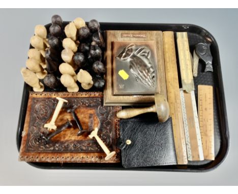 A tray of carved wooden tribal chess pieces, leather wallet, wooden rulers including folding bone example, pocket knife etc 