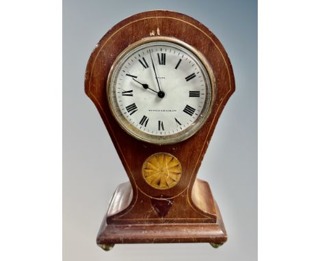 A late Victorian inlaid mahogany balloon mantel clock on brass ball feet  CONDITION REPORT: one foot missing 