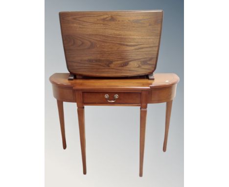 An Ercol elm and beech flap sided coffee table in antique finish, width 69 cm,  together with a Regency style yew wood hall t