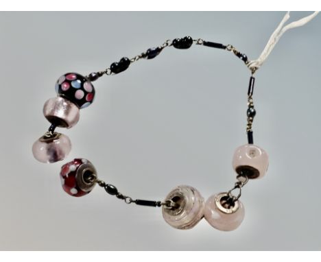 Seven silver Rhona Sutton bead charms 