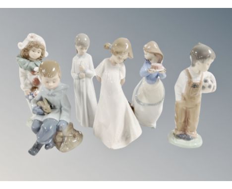 Six Nao figures including puppies birthday, boy with rabbit etc 