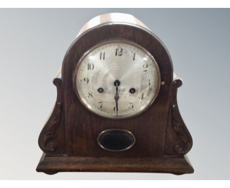 An early 20th century Junghans oak cased mantel clock with silvered dial 