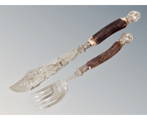A serving knife and fork  with horn handles