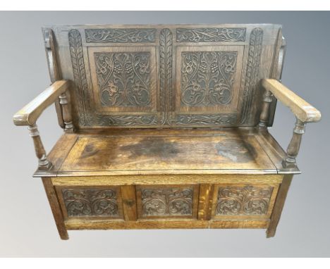 A heavily carved oak monk's bench 