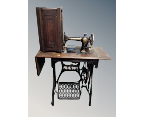 A vintage Jones treadle sewing machine in table 