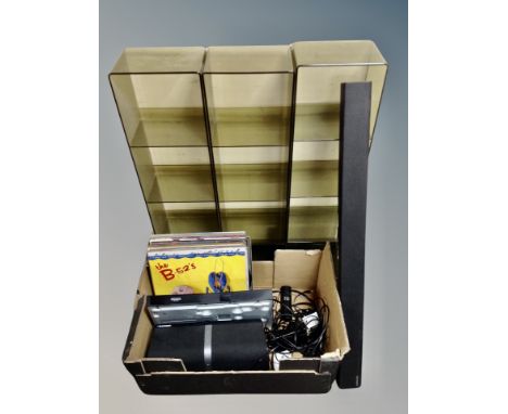 Three opaque plastic media stands together with a box of Samsung blu-ray player, sound bar, Blaupunkt speaker, leads and remo